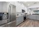 Bright kitchen featuring stainless steel appliances, granite countertops, and white and gray cabinetry at 829 Terranova Rd, Winter Haven, FL 33884