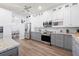 Open kitchen with white cabinets, stainless appliances, granite counters, and an open view to the dining room at 829 Terranova Rd, Winter Haven, FL 33884