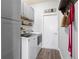 Functional laundry room with modern appliances, shelving, and ample cabinet space at 829 Terranova Rd, Winter Haven, FL 33884