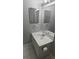 Bright bathroom with white vanity, sink, and mirror at 8347 Willowwood St, Orlando, FL 32818