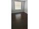 Bedroom with dark wood flooring, natural light, and neutral wall color at 8347 Willowwood St, Orlando, FL 32818