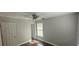 Comfortable bedroom with dark wood flooring, ample lighting, and closet at 8347 Willowwood St, Orlando, FL 32818