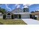 Charming two-story home with a well-maintained front yard and attached two car garage at 8347 Willowwood St, Orlando, FL 32818