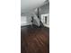 Inviting living room featuring dark wood floors, natural light, and staircase at 8347 Willowwood St, Orlando, FL 32818