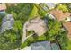 Aerial view of a luxurious home and lush tropical landscaping with a long driveway at 8740 Ingleton Ct, Orlando, FL 32836