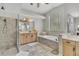 Bright bathroom with dual vanities, a glass block window, and a soaking tub at 8740 Ingleton Ct, Orlando, FL 32836