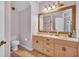 Traditional bathroom with a large mirror, double vanity and nice lighting at 8740 Ingleton Ct, Orlando, FL 32836