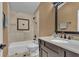 Bathroom featuring a tub/shower combo, and dark vanity with solid surface at 8740 Ingleton Ct, Orlando, FL 32836