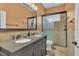 Bathroom features a double sink vanity, large framed mirror and glass shower stall at 8740 Ingleton Ct, Orlando, FL 32836