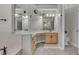 Bright bathroom with mirrors, vanities, and marble floors at 8740 Ingleton Ct, Orlando, FL 32836