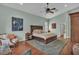 Spacious bedroom featuring a plush rug, artwork, and a comfortable king-size bed at 8740 Ingleton Ct, Orlando, FL 32836