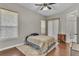 This cozy bedroom offers natural light, hardwood floors, and neutral paint at 8740 Ingleton Ct, Orlando, FL 32836
