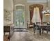 Formal dining room with high ceilings, double doors to the garden, and an elegant chandelier at 8740 Ingleton Ct, Orlando, FL 32836
