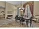 Elegant dining room features a chandelier, large window with decorative drapes, and tile flooring at 8740 Ingleton Ct, Orlando, FL 32836