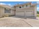 Three car garage with a concrete driveway and manicured landscaping at 8740 Ingleton Ct, Orlando, FL 32836