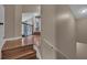 Hallway with hardwood floors leading to the staircase to the lower level at 8740 Ingleton Ct, Orlando, FL 32836