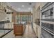 Gourmet kitchen with granite countertops, stainless steel appliances, and a center island with a sink at 8740 Ingleton Ct, Orlando, FL 32836
