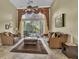 Bright living room with high ceilings, large windows overlooking the pool area, and comfortable seating at 8740 Ingleton Ct, Orlando, FL 32836