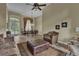Spacious living room featuring neutral tones, large windows, decorative drapes, and tile flooring at 8740 Ingleton Ct, Orlando, FL 32836
