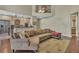 Open-concept living area with a view of the kitchen, a comfortable sofa, and hardwood flooring at 8740 Ingleton Ct, Orlando, FL 32836