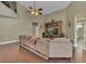 Inviting living room featuring a ceiling fan, wood floors, and entertainment center at 8740 Ingleton Ct, Orlando, FL 32836