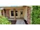 Inviting front entrance featuring a covered porch and brick accents, adding charm and curb appeal to the home at 10025 Chesham Dr, Orlando, FL 32817