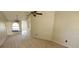 Bright living room with carpeted floors, ceiling fan and natural light from large window, creating a comfortable atmosphere at 10025 Chesham Dr, Orlando, FL 32817