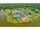 Aerial view of community amenities: pool, clubhouse, tennis courts and lakeside access at 1091 Hampstead Ln, Ormond Beach, FL 32174