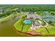 Aerial view of the community pool, clubhouse, and tennis courts near the lake at 1091 Hampstead Ln, Ormond Beach, FL 32174