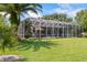 Expansive backyard with a screened-in patio, ideal for outdoor living and entertaining at 1091 Hampstead Ln, Ormond Beach, FL 32174