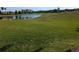Lush green lawn overlooking a tranquil lake and golf course in the backyard at 1091 Hampstead Ln, Ormond Beach, FL 32174