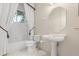 Clean bathroom with a pedestal sink, toilet, and shower with curtain at 1091 Hampstead Ln, Ormond Beach, FL 32174