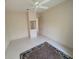 Clean, minimalist bedroom with neutral walls, tile floors, and ceiling fan at 1091 Hampstead Ln, Ormond Beach, FL 32174