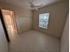 Bedroom features tile flooring, a ceiling fan, a window, and a closet, creating a comfortable living space at 1091 Hampstead Ln, Ormond Beach, FL 32174