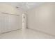Comfortable bedroom with tile floors, a ceiling fan, and a closet with paneled doors at 1091 Hampstead Ln, Ormond Beach, FL 32174