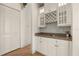 Charming butler pantry with custom cabinetry, wine rack, and granite countertop, ideal for entertaining at 1091 Hampstead Ln, Ormond Beach, FL 32174