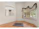 Dining room featuring hardwood floors and a decorative mirror reflecting the screened-in lanai at 1091 Hampstead Ln, Ormond Beach, FL 32174