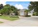 Attractive stone-accented home with well-maintained landscaping, a spacious driveway, and mature trees at 1091 Hampstead Ln, Ormond Beach, FL 32174