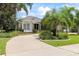 Elegant stone-accented home with well-manicured landscaping, a spacious driveway, and mature trees at 1091 Hampstead Ln, Ormond Beach, FL 32174