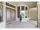 Elegant front entrance with double doors, stone accents, and a tiled porch at 1091 Hampstead Ln, Ormond Beach, FL 32174