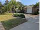Landscaped front yard with palm trees and circular driveway at 1091 Hampstead Ln, Ormond Beach, FL 32174