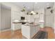 Spacious kitchen featuring a central island with granite countertops and pendant lighting at 1091 Hampstead Ln, Ormond Beach, FL 32174
