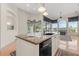 Kitchen island with black sink, granite countertops, and open view of the sunroom and fireplace at 1091 Hampstead Ln, Ormond Beach, FL 32174