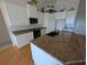 Updated kitchen features granite countertops, white cabinets and hardwood flooring at 1091 Hampstead Ln, Ormond Beach, FL 32174