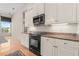 Kitchen cabinets with granite countertops and modern appliances, offering a view of the adjacent room at 1091 Hampstead Ln, Ormond Beach, FL 32174