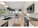 View of the kitchen with an island, modern appliances, and an open layout to the living area at 1091 Hampstead Ln, Ormond Beach, FL 32174