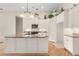 Kitchen island with granite countertop and pendant lights, offering a view to the kitchen and breakfast area at 1091 Hampstead Ln, Ormond Beach, FL 32174