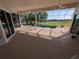 Screened-in lanai overlooking the pool, golf course, and pond at 1091 Hampstead Ln, Ormond Beach, FL 32174
