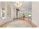 Spacious living room featuring hardwood floors, elegant lighting, and large windows offering scenic views at 1091 Hampstead Ln, Ormond Beach, FL 32174