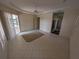 Bright and airy room with neutral tones, tiled floors, a ceiling fan, and sliding glass doors to the backyard at 1091 Hampstead Ln, Ormond Beach, FL 32174